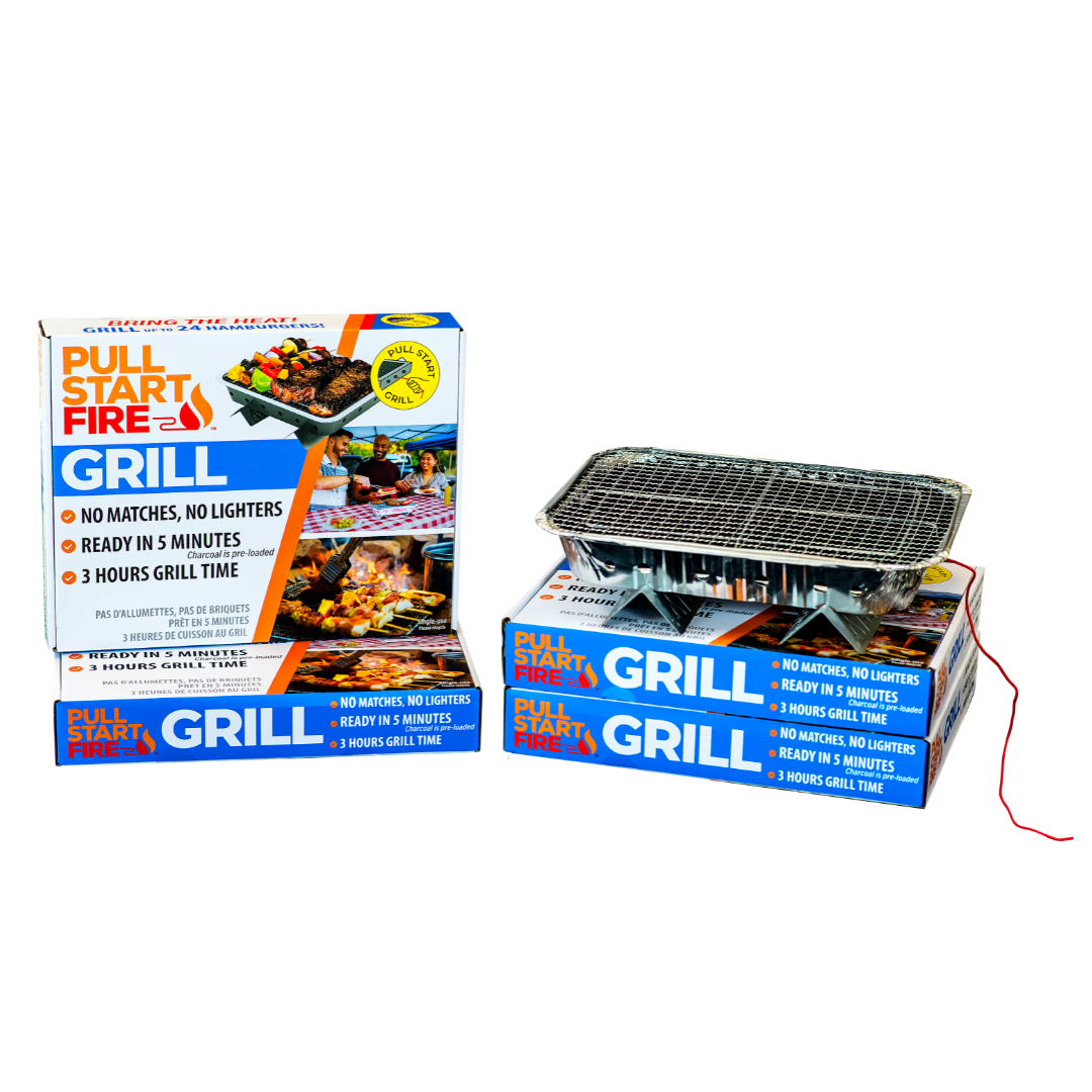 A portable charcoal grill sitting on top of two boxes of packaging and placed beside two more boxes.