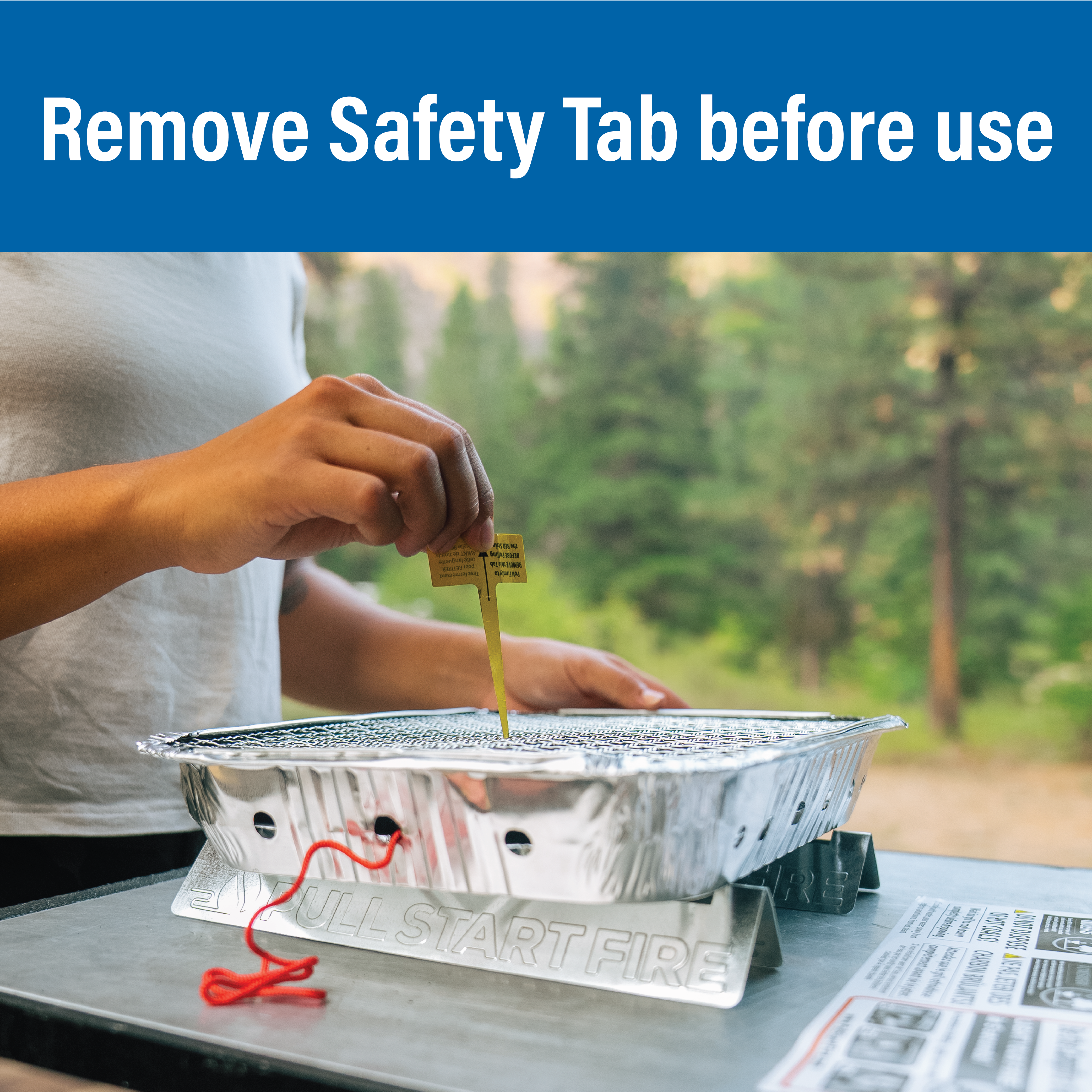 A person pull the safety tab of a Pull Start Fire matchless portable grill before use.